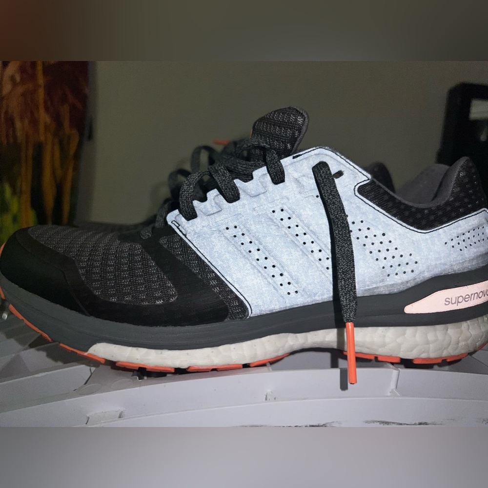 Woman, Adidas boost supernova